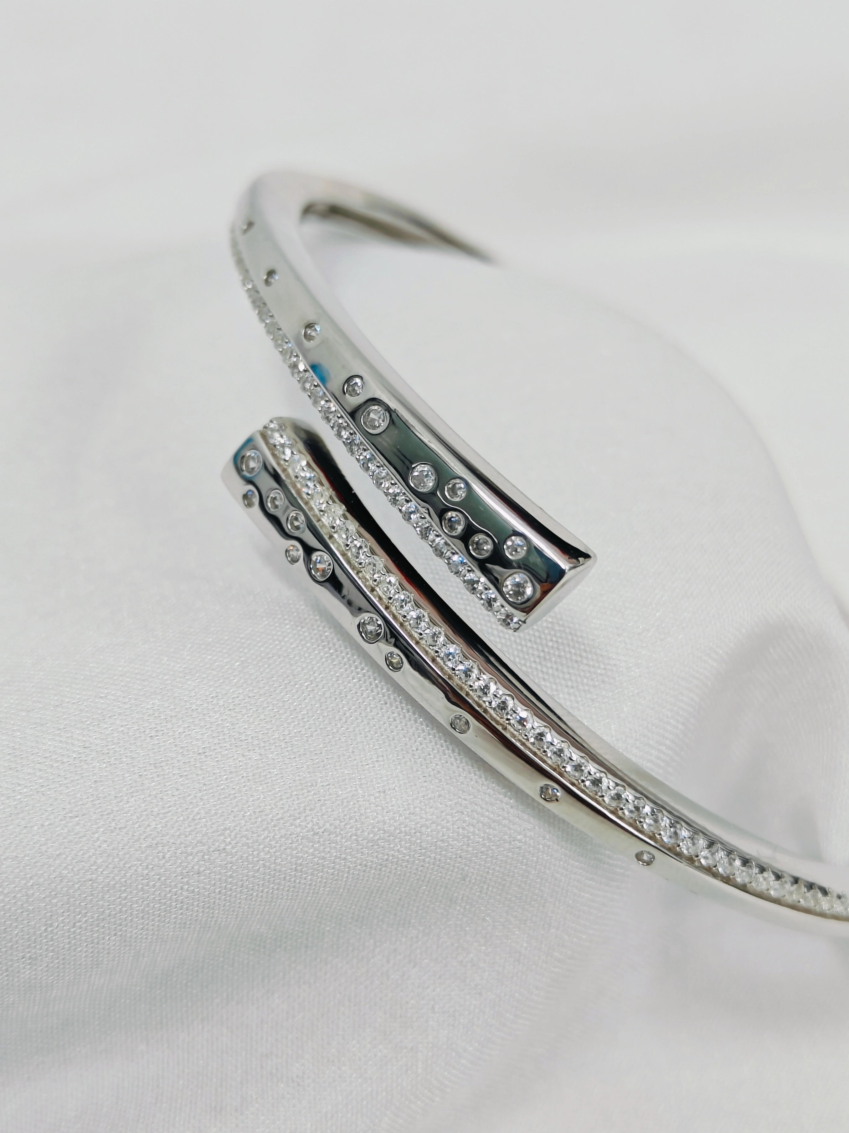 Silver bracelet with gemstones on a white background